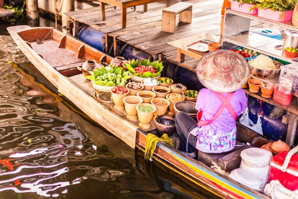 unrecognizable-thai-food-peddler-selling-fruit