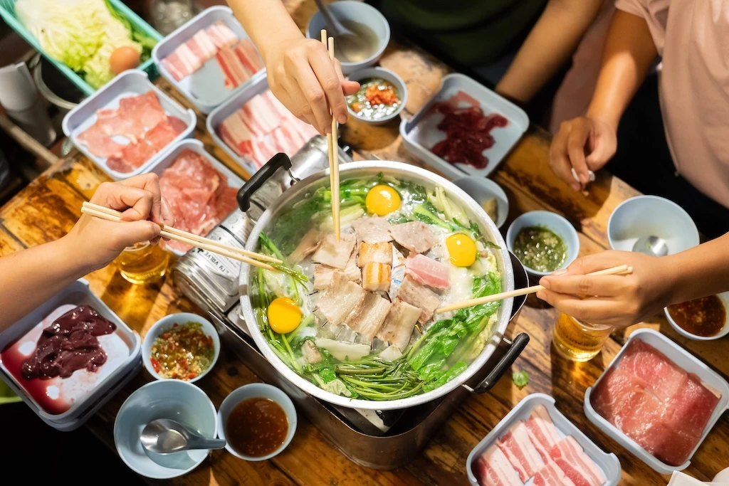 hand-holding-chopsticks-eating-thai-barbecue